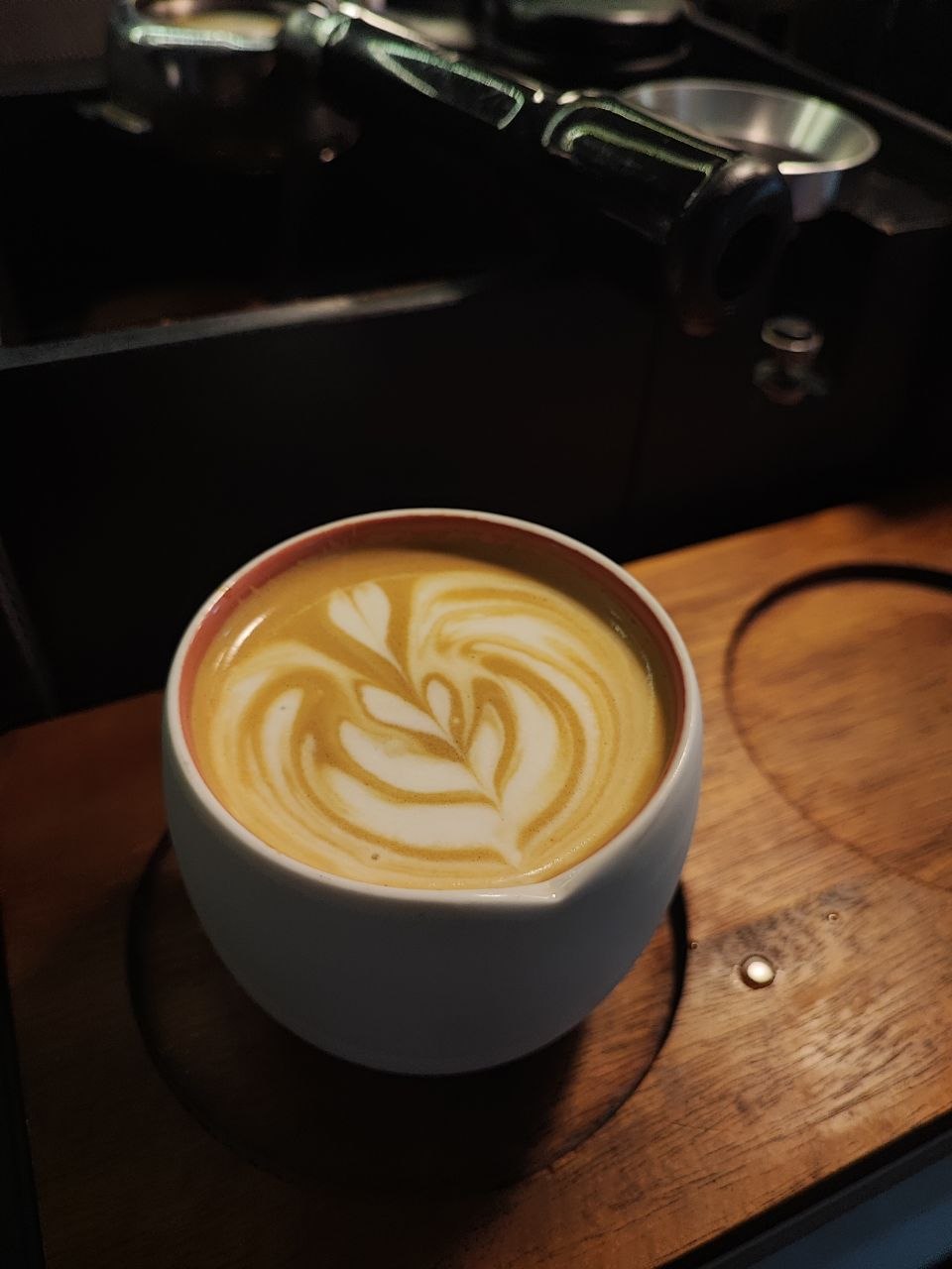 Latte art in a ceramic cup on espresso machine