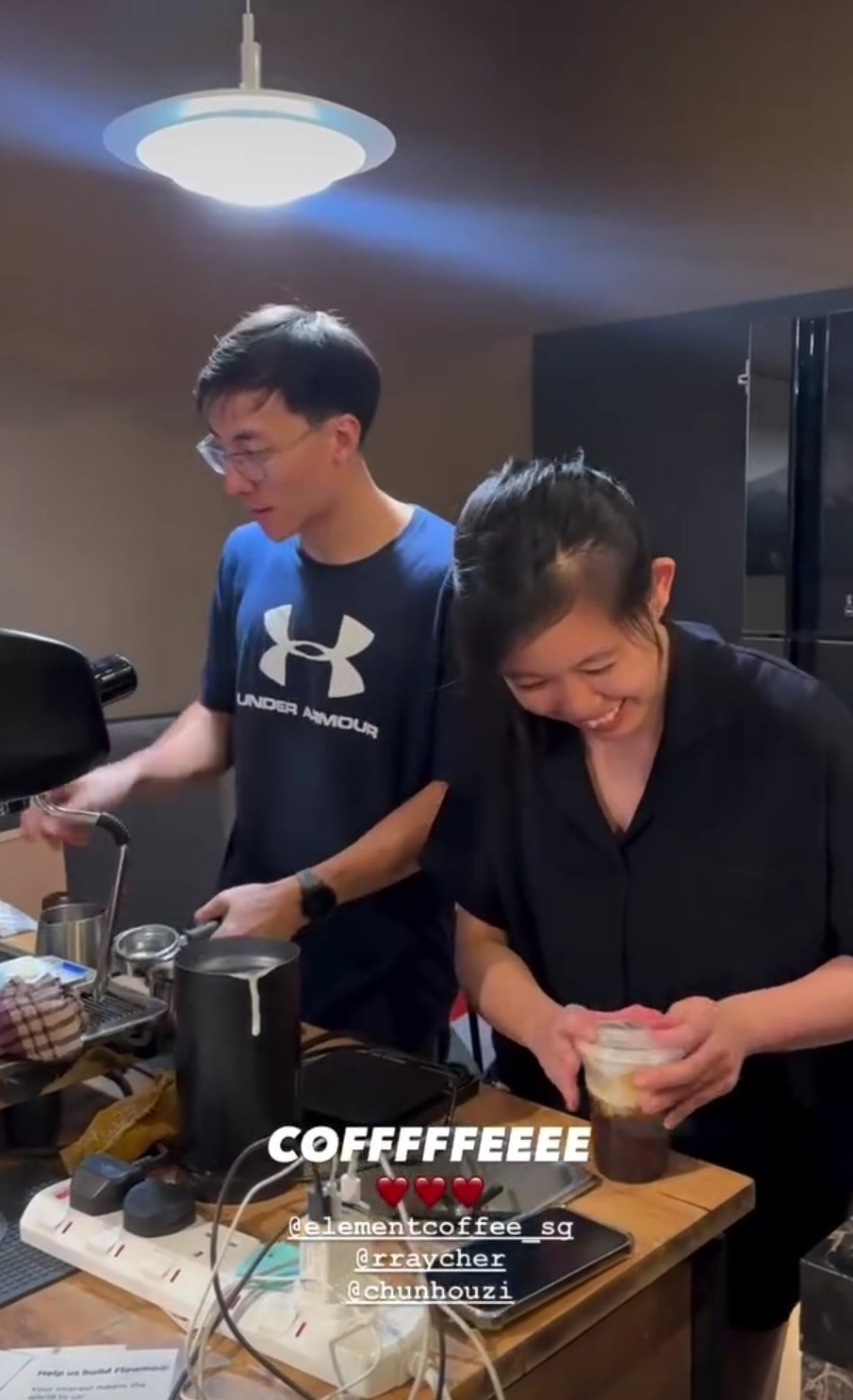 Baristas pulling shots and pouring drinks at the cart